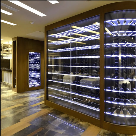 Luxury commercial wine storage cabinets with glass doors and LED-lit shelves displaying wine bottles in a modern hospitality interior