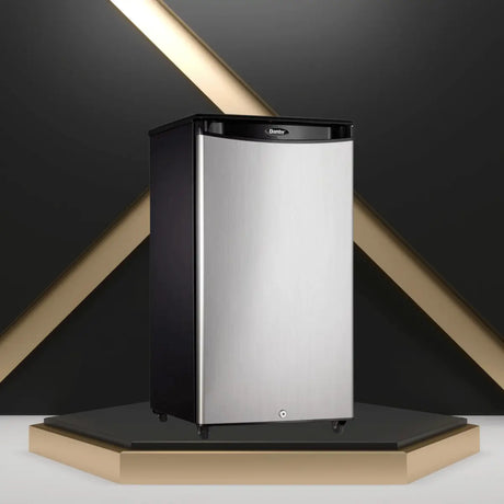 Outdoor refrigerator with stainless steel door and compact design, displayed in a modern studio setting for outdoor kitchen use.