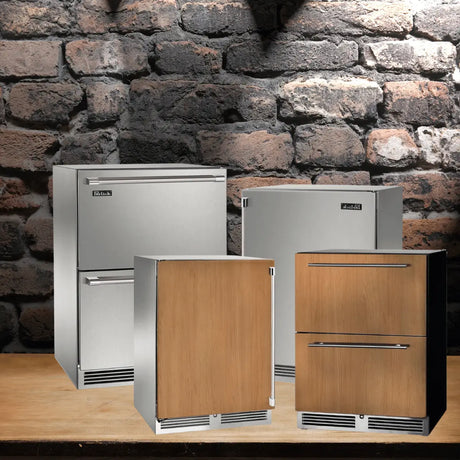 Perlick freezers collection featuring under-counter stainless steel and wood-panel-ready freezer units displayed against a brick wall.