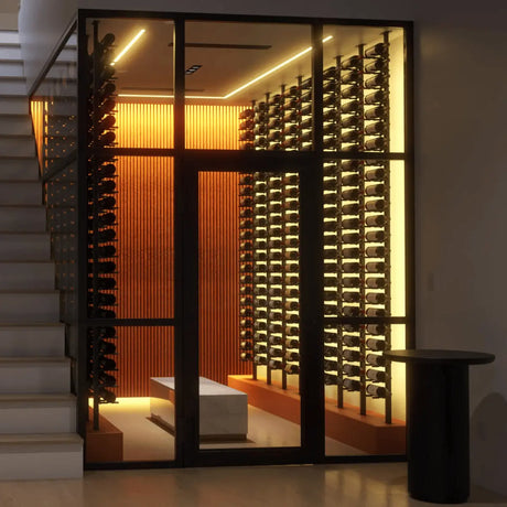 Minimalist glass-enclosed wine room with tall Ultra Wine Racks displaying bottles in sleek label-forward rows with warm ambient lighting.