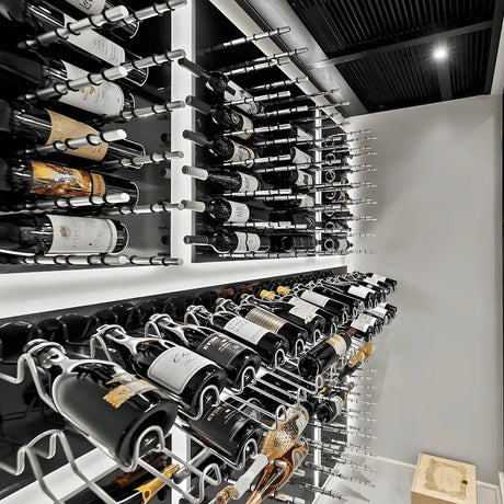 Modern wine cellar display with metal wine pegs holding bottles horizontally on illuminated panels for a sleek, contemporary storage look.