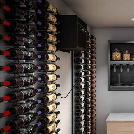 WhisperKOOL SC PRO 3000 installed near the ceiling in a wine cellar corner surrounded by bottle storage racks